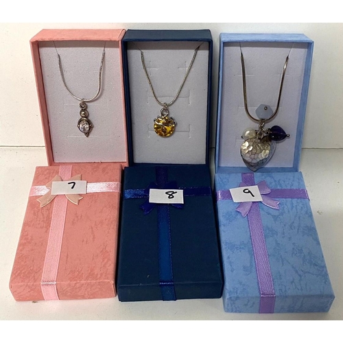 26 - Three 925 silver chains with varying pendants including a heart pendant with beads and an amber ston... 