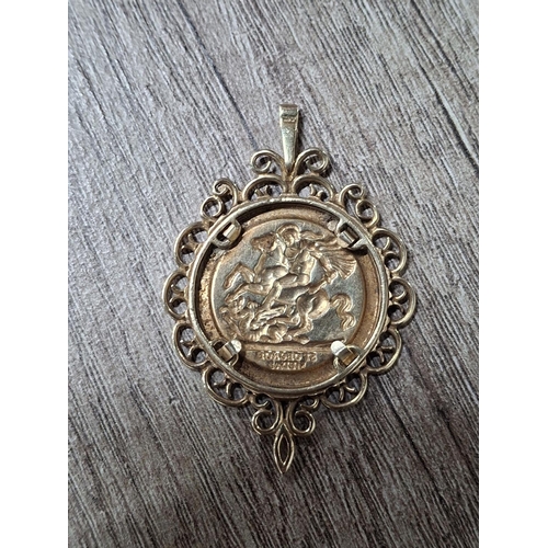 41 - 9ct yellow gold with tiny hallmark of a surround and a sovereign like coin marked 