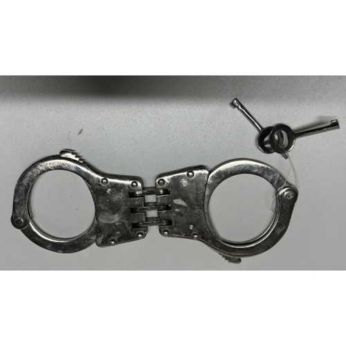 77 - Metal hand cuffs with keys