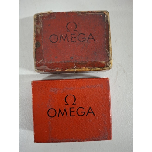 208 - Two boxed and retaining their original bags are 2 Omega stop watches (2)