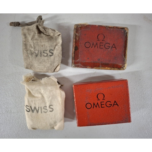 208 - Two boxed and retaining their original bags are 2 Omega stop watches (2)