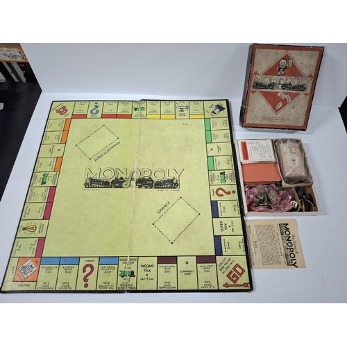 210 - Very old Monopoly which appears to be possibly complete together with an old chess set with resin pi... 