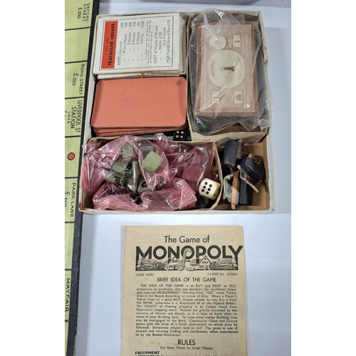 210 - Very old Monopoly which appears to be possibly complete together with an old chess set with resin pi... 