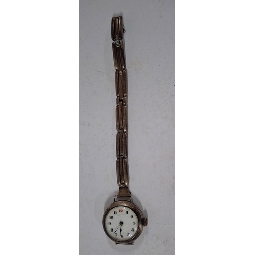 219 - A silver ladies Trench Watch along with a photo in a watch, as found