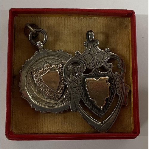 122 - Two silver shield shaped watch fobs (2)