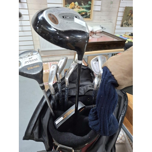 397 - Set of Wilson golf irons (3-SW) in a Wilson carry bag together with a Wilson Matrix driver and a Spa... 