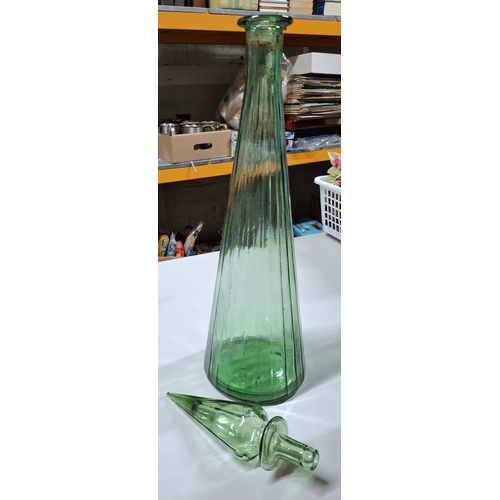 112 - Large floor standing brown bottle (56cm tall) with corked top together with a large green bottle wit... 