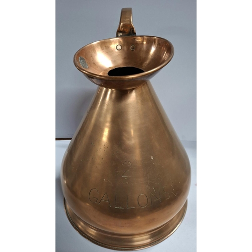 57 - Two gallon copper measuring jug