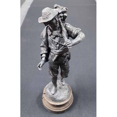 105 - An old heavy spelter sculpture on base of a figure carrying wood