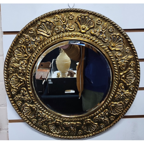 242 - A fine quality round bevelled edge mirror surrounded with shell decoration in Brass

measures 43cm i... 