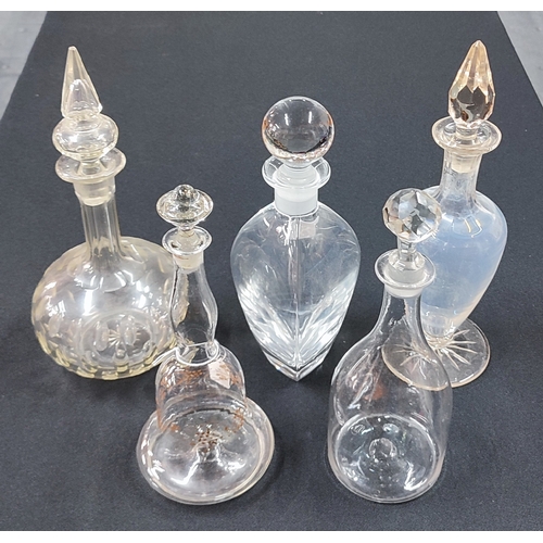 434 - Four antique glass decanters and a later oval base example, all with their respective stoppers (5)