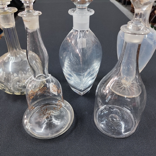 434 - Four antique glass decanters and a later oval base example, all with their respective stoppers (5)