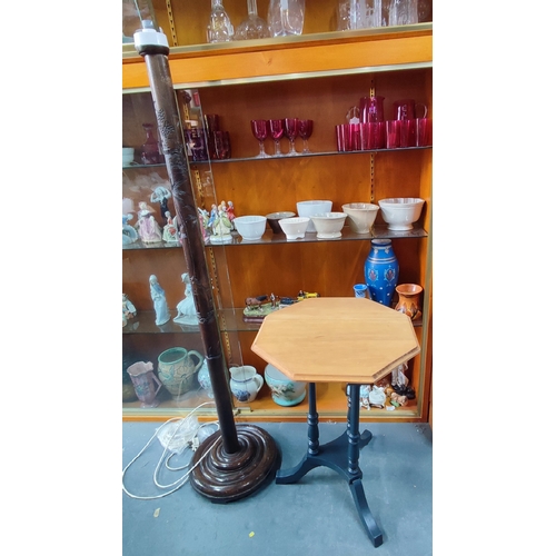 518 - A carved oriental floor lamp and an octagonal lamp table (2)