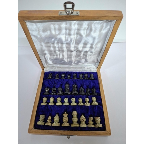 57 - Fine quality later 20thC chess set with carved soft stone pieces housed within a wooden carry box, t... 