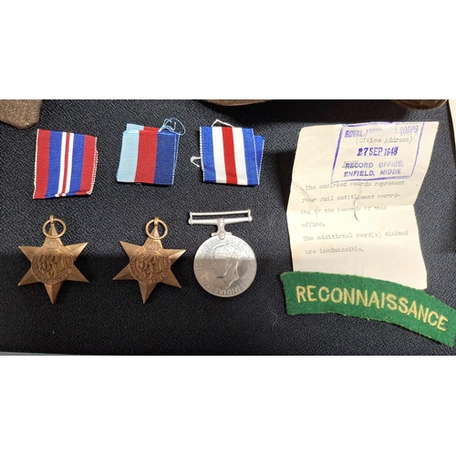 77 - WWII medals, tunic and other badges, cap badge and paperwork for 7518741 Sargent Jack A Chisnall of ... 