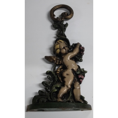 192 - Finely cast, old cast-iron door stop in the form of a cherub.