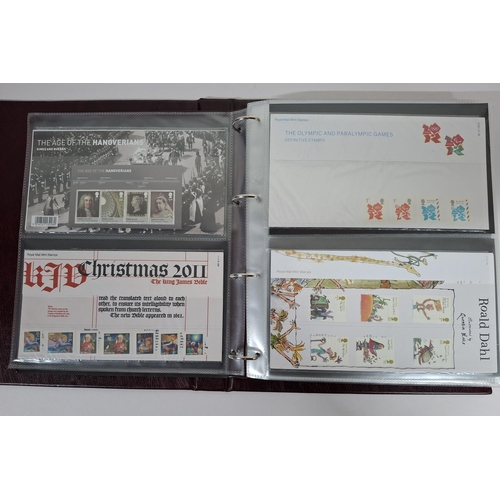 235 - Two burgundy Royal mail albums containing Queen Elizabeth GB stamp presentation packs October 2011-N... 