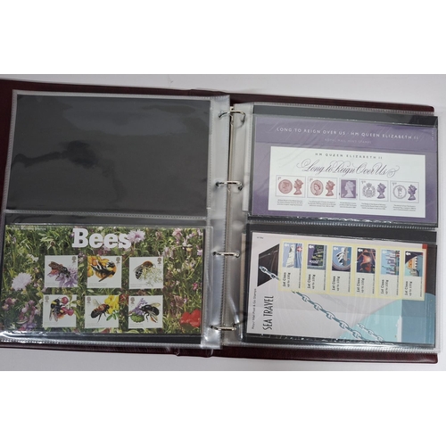 235 - Two burgundy Royal mail albums containing Queen Elizabeth GB stamp presentation packs October 2011-N... 