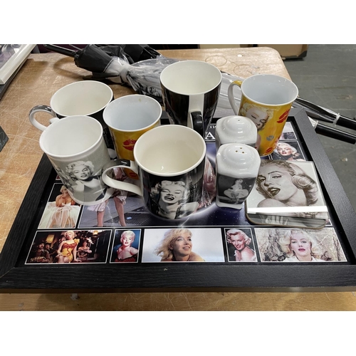 342 - Marilyn Munroe memorabilia which includes a knee tray, mugs and two umbrellas