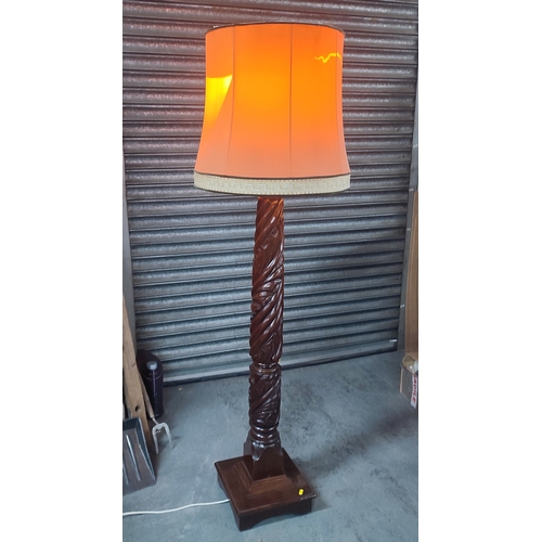 389 - An ornately carved floor lamp