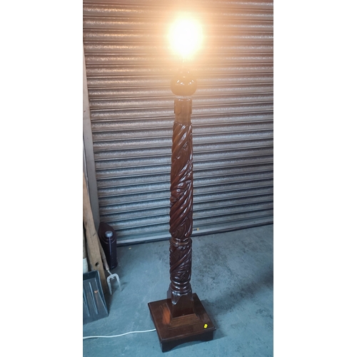 389 - An ornately carved floor lamp