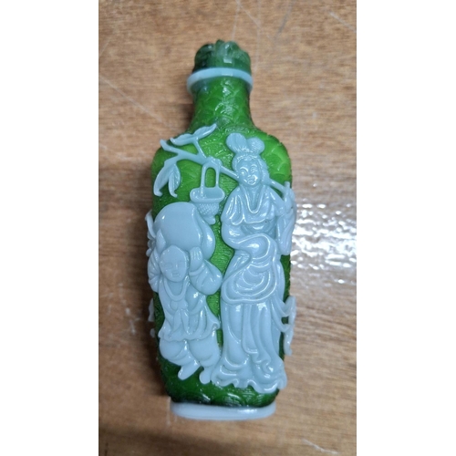 357 - Oriental snuff bottle in green glass with applied figurative decoration