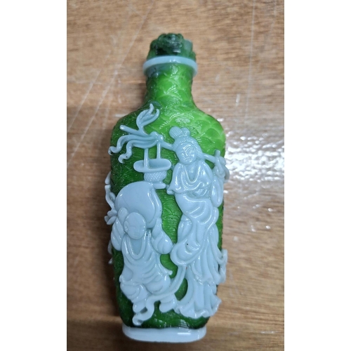 357 - Oriental snuff bottle in green glass with applied figurative decoration