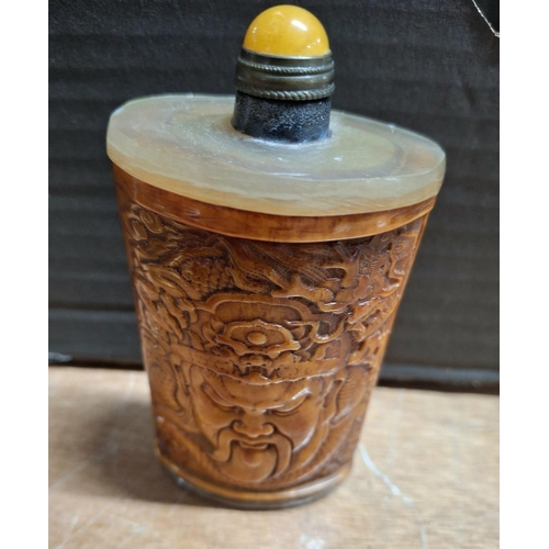 359 - Oriental snuff bottle in amber style material with a crowned elders face