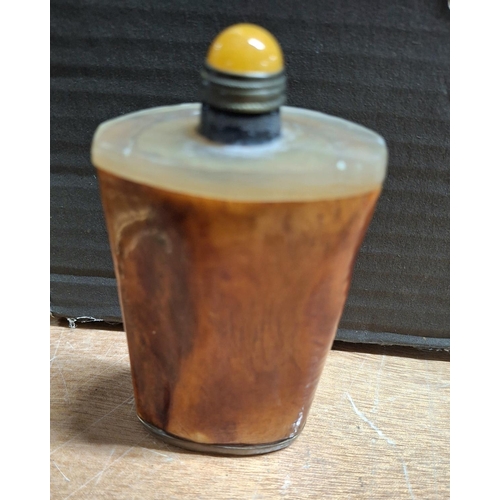 359 - Oriental snuff bottle in amber style material with a crowned elders face