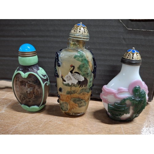 367 - Three decorated fine coloured glass Oriental snuff bottles (3)