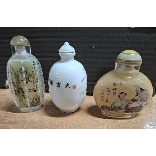 369 - Porcelain snuff bottle with Cockerill decoration together with two coloured glass Oriental snuff bot... 