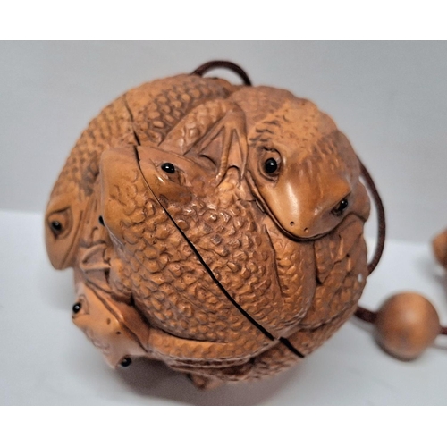 31 - Netsuke Frog ball with tiny glass eyes together with a carved toggle of a Frog on an Acorn