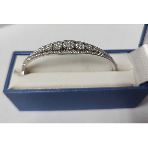 89 - A stunning 18ct. White Gold and Diamond bracelet, boat shaped with a central line of cluster Diamond... 