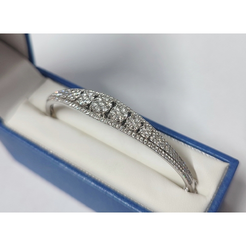 89 - A stunning 18ct. White Gold and Diamond bracelet, boat shaped with a central line of cluster Diamond... 