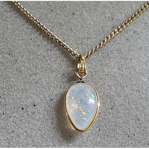 187 - Large whole Opal pendant in teardrop form set in 9ct yellow gold and comes on a hallmarked 9ct yello... 