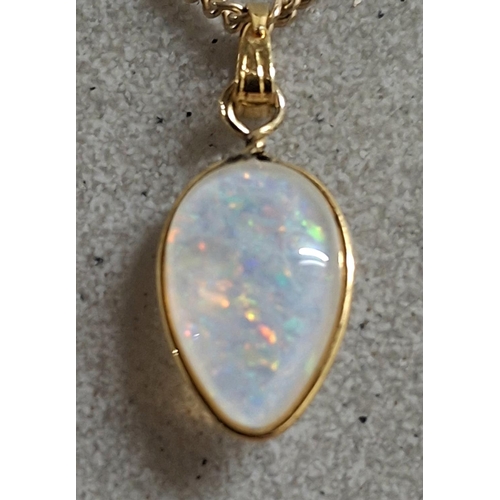 187 - Large whole Opal pendant in teardrop form set in 9ct yellow gold and comes on a hallmarked 9ct yello... 