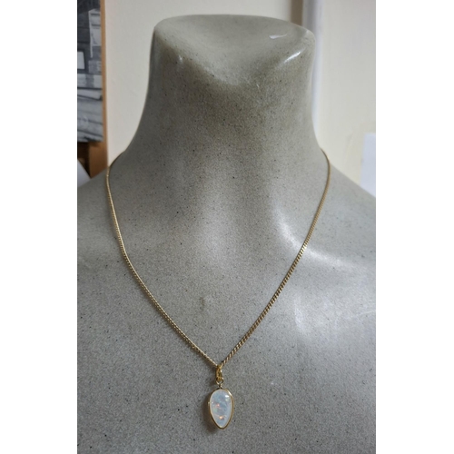 187 - Large whole Opal pendant in teardrop form set in 9ct yellow gold and comes on a hallmarked 9ct yello... 