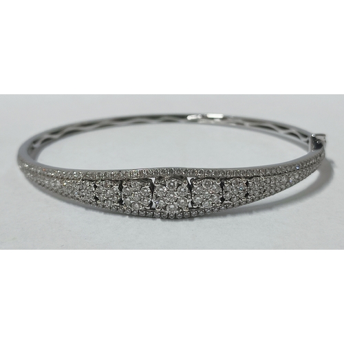 89 - A stunning 18ct. White Gold and Diamond bracelet, boat shaped with a central line of cluster Diamond... 