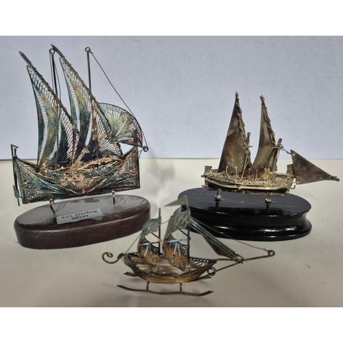 23 - Set of three silver filigree worked boats, 2 on wood stands (3)