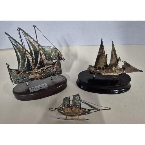 23 - Set of three silver filigree worked boats, 2 on wood stands (3)