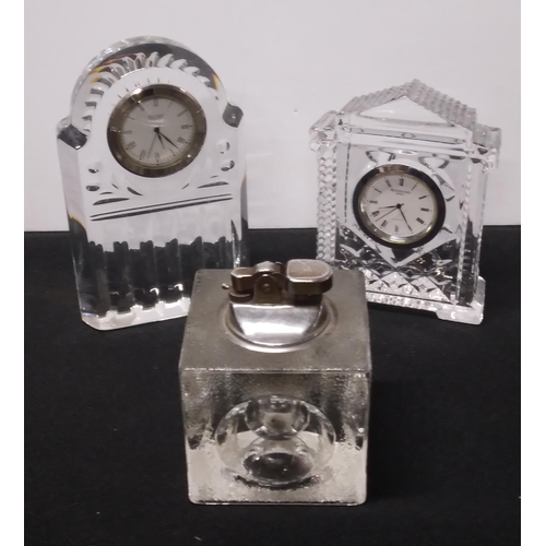 91 - Stuart and Waterford crystal mantle clocks together with a retro table top glass lighter (3)