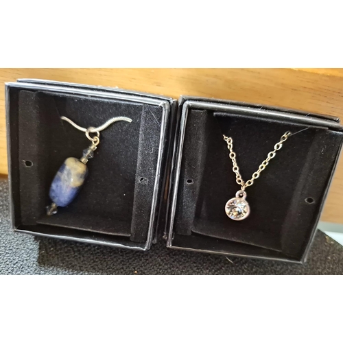 74 - Four 925 silver chains with a round crystal pendant, a blue stone bead pendant and a large solitaire... 