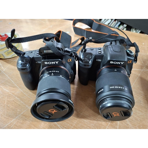 339 - Two Sony Alpha 360 cameras complete with associated lens and other accessories in its official carry... 