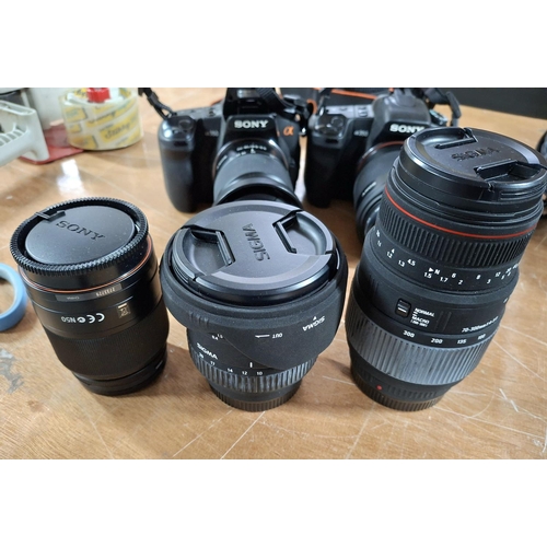 339 - Two Sony Alpha 360 cameras complete with associated lens and other accessories in its official carry... 