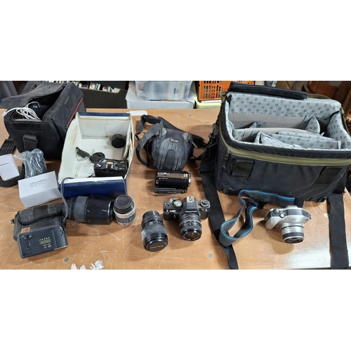 340 - Quantity of cameras and accessories to include a Praktica BX20 with lens, a Panasonic 80x cinecam et... 