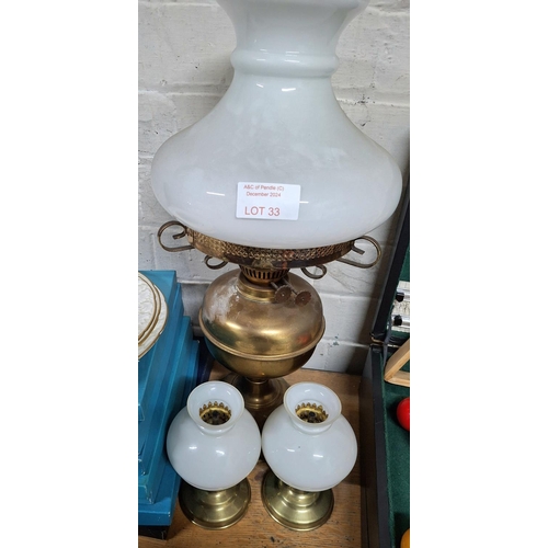 33 - Antique brass oil lamp with milk glass shade together with 2 other smaller examples (3)