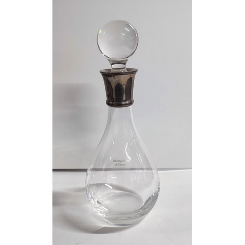 20 - A hallmarked silver collared crystal decanter with stoppper