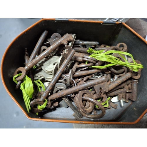 99 - Tin containing a quantity of rusty old keys including many cabinet keys (Qty)