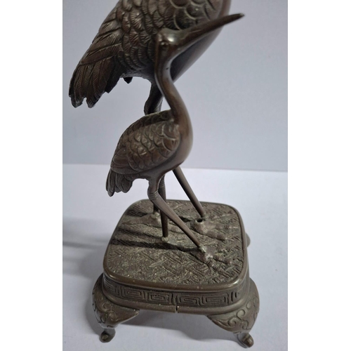 144 - Japanese cast bronze depicting two Herons,

approx 25cm tall         approx 700 grams