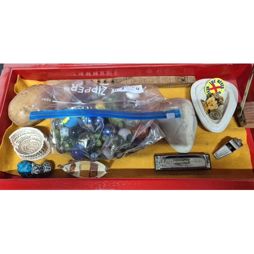 170 - wood vintage first aid tin containign collectables including a bag of marbles, a harmonica and a whi... 